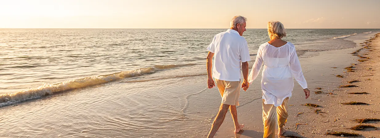 Senior Paar spaziert am Strand