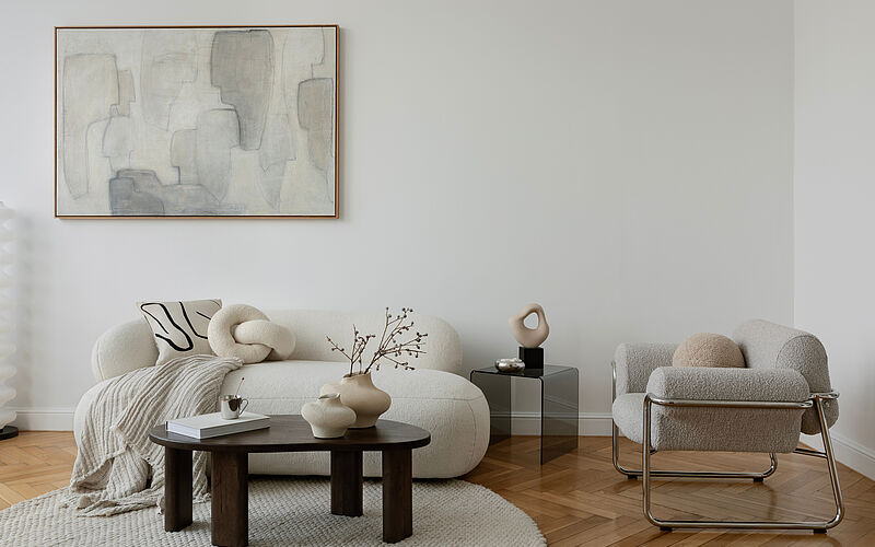Modern eingerichtetes Wohnzimmer mit Designermöbeln, heller Atmosphäre und dezenten Dekorationen.