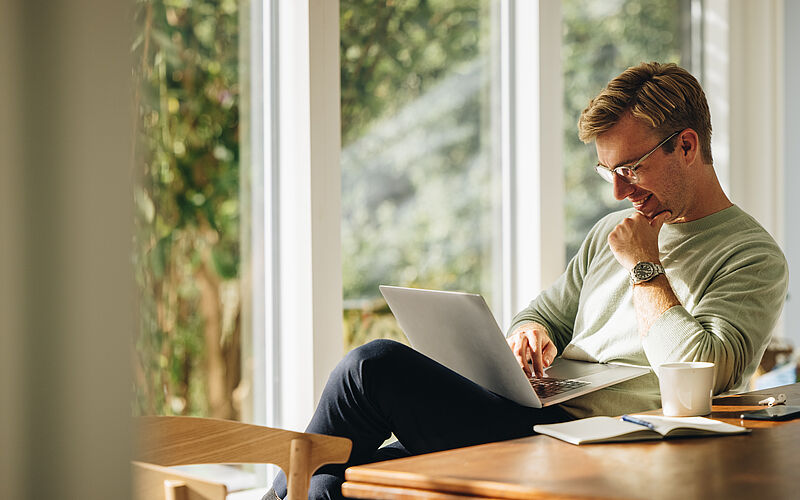 Mann zu Hause mit Laptop