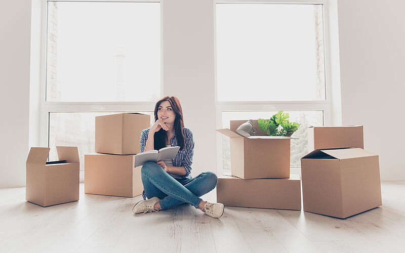 frau mit kartons beim umzug